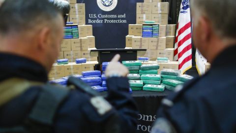 Police officers stand guard near cocaine seized from the cargo ship.