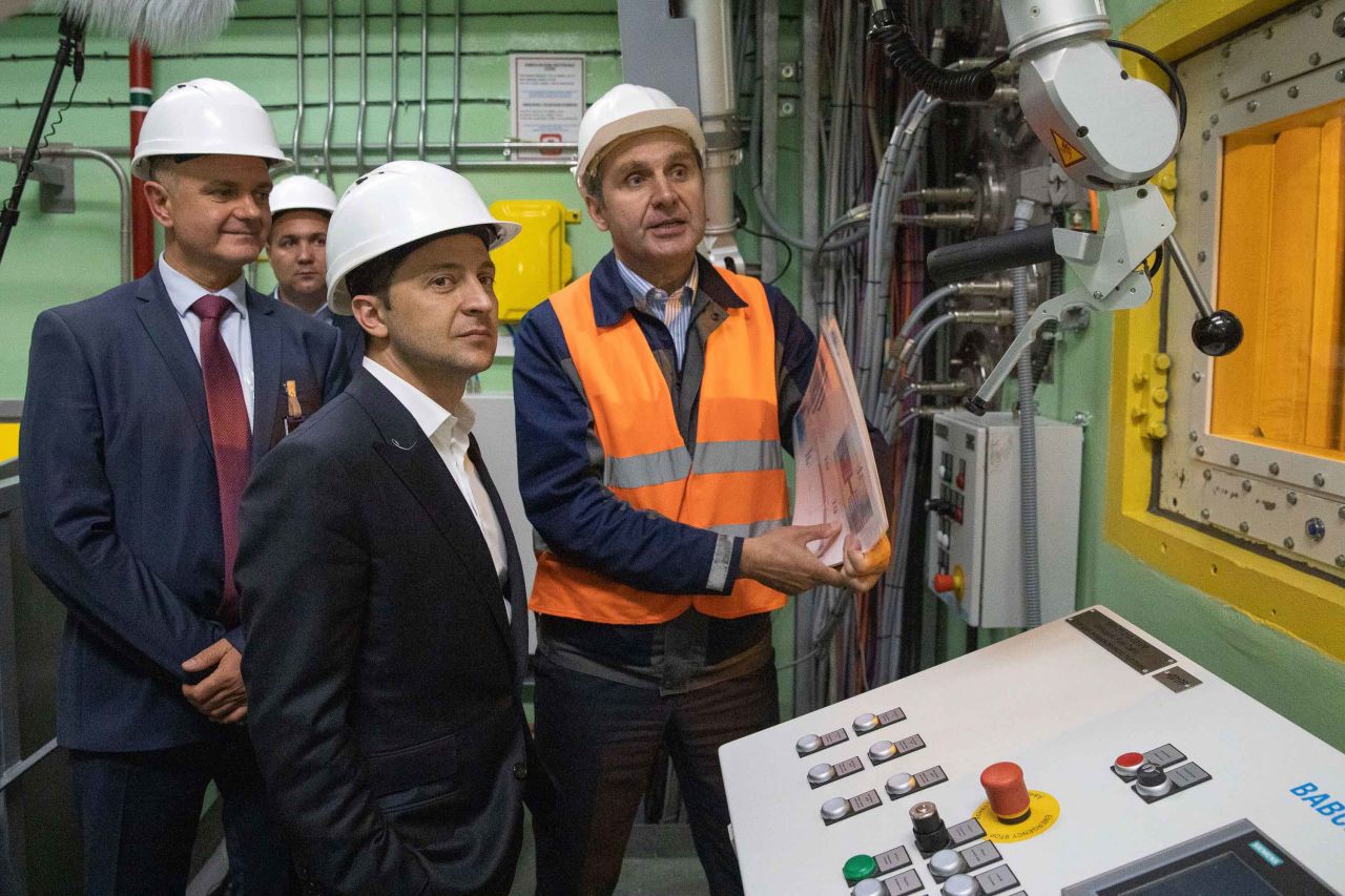 Ukrainian President Volodymyr Zelenskiy, foreground, visits the "new safe confinement" shelter that spans the remains of the Chernobyl nuclear power plant's Reactor No. 4, in Chernobyl(Ukrainian Presidential Press Office via AP)