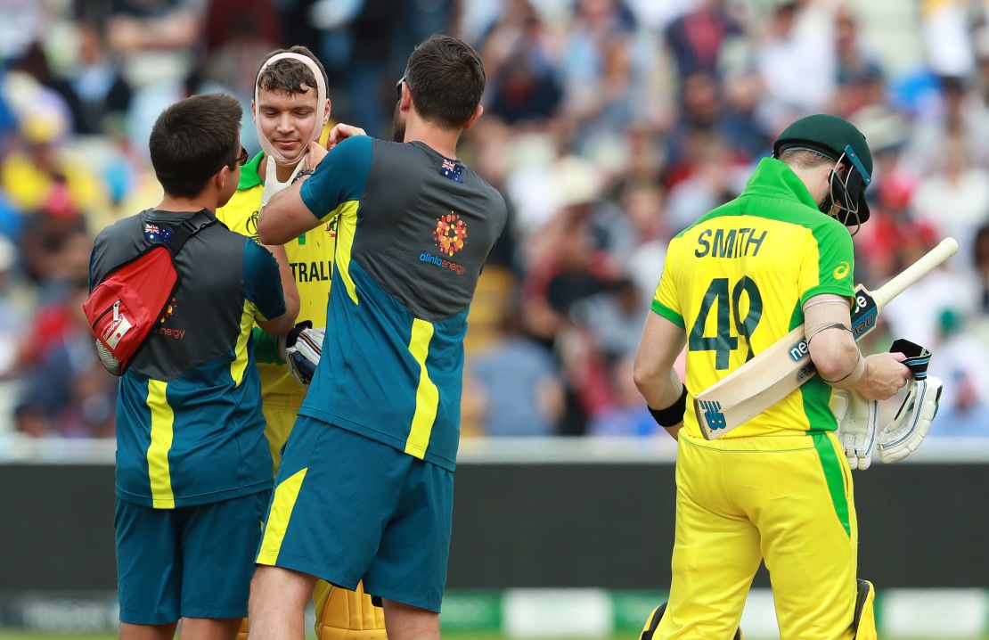 Alex Carey receives further medical treatment following a cut to the chin.