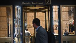 A man is seen outside the US headquarters of Deutsche Bank on July 8, 2019 in New York City. - From Asia to the United States, disconsolate staff at Deutsche Bank dealt Monday with news of massive layoffs with some already heading to the exits to drown their sorrows.The German giant's share price fell to a low of 6.66 euros ($7.47) before closing down 5.4 percent at 6.79 euros, following Sunday's announcement of 18,000 job losses by 2022 as the company transitions out of high-risk investment banking. (Photo by Angela Weiss / AFP)        (Photo credit should read ANGELA WEISS/AFP/Getty Images)