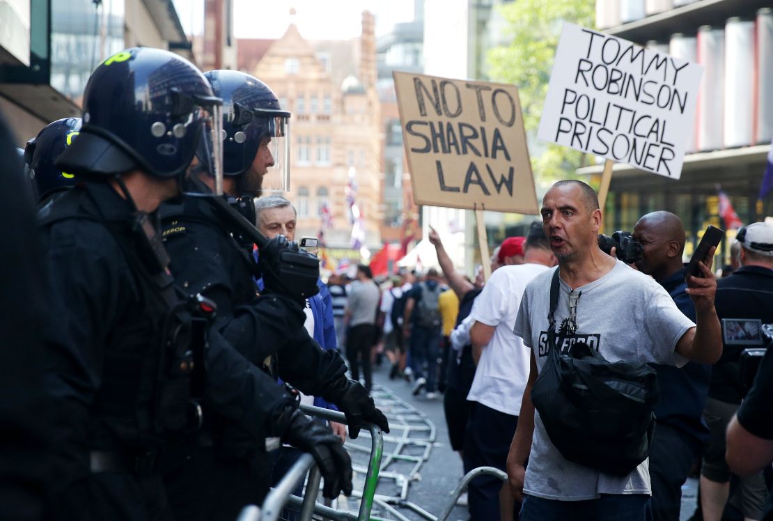 Tommy Robinson's supporters protest outside London's Old Bailey after the far-right activist was sentenced to nine months in prison for contempt of court.