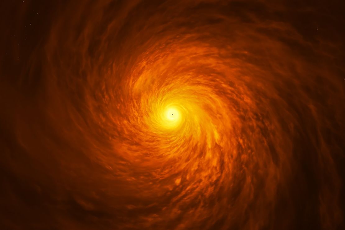 An artist's impression of the view looking down at a thin disc of material circling a supermassive black hole.