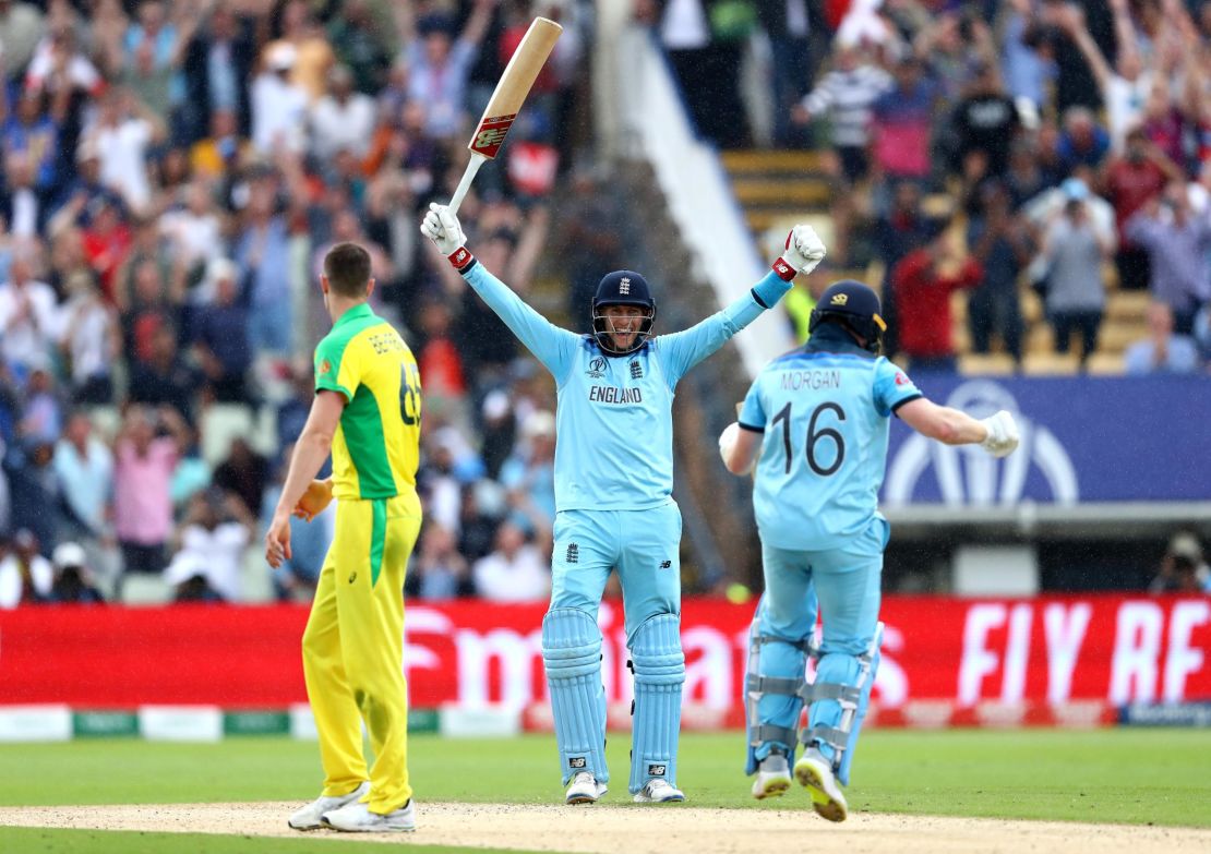 Joe Root celebrates as Eoin Morgan of England scores the winning runs to secure victory.