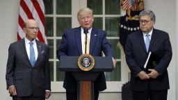 President Donald Trump is joined by Commerce Secretary Wilbur Ross and Attorney General William Barr, right, as he speaks in the Rose Garden at the White House in Washington, Thursday, July 11, 2019. (AP Photo/Carolyn Kaster)