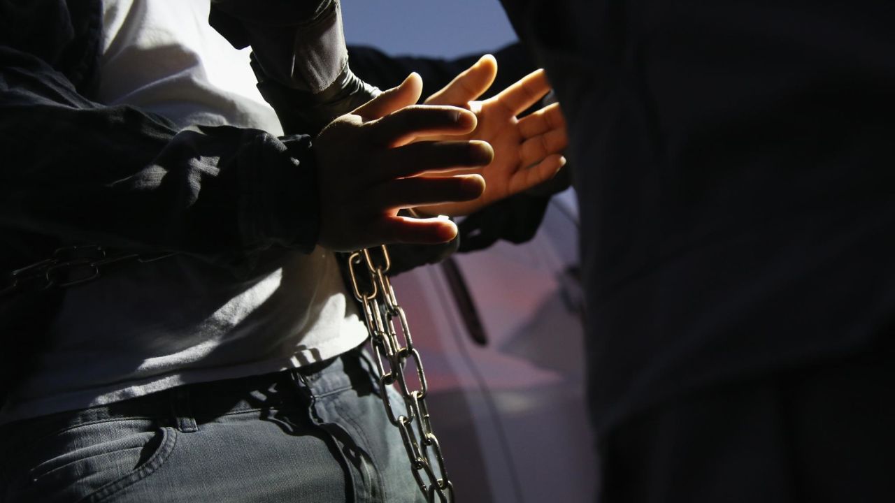 A man is detained by Immigration and Customs Enforcement agents on October 14, 2015, in Los Angeles, California.