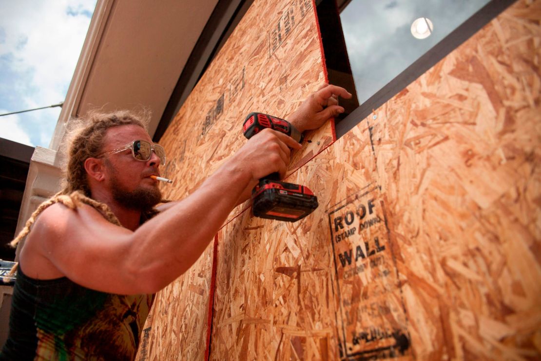 Matt Harrington boards up a Vans shoe store near the French Quarter in New Orleans as Tropical Storm Barry approaches.