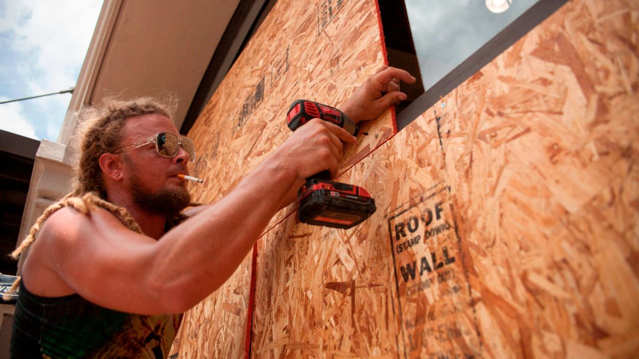 Matt Harrington boards up a Vans shoe store near the French Quarter in New Orleans as Tropical Storm Barry approaches.