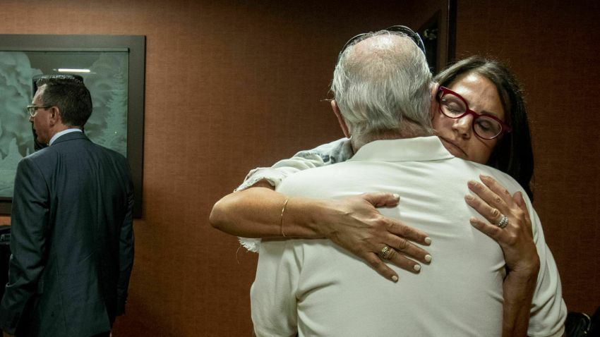Tanya Gersh, a Montana real estate agent, embraces her father Lloyd Rosenstein following a hearing at the Russell Smith Federal Courthouse on Thursday, July 11, 2019, in Missoula. Gersh is the plaintiff in a harassment lawsuit filed against Daily Stormer publisher Andrew Anglin. Gersh, who is Jewish, said she and her family received hundreds of threatening messages, many of them anti-Semitic. (Ben Allen/The Missoulian via AP)