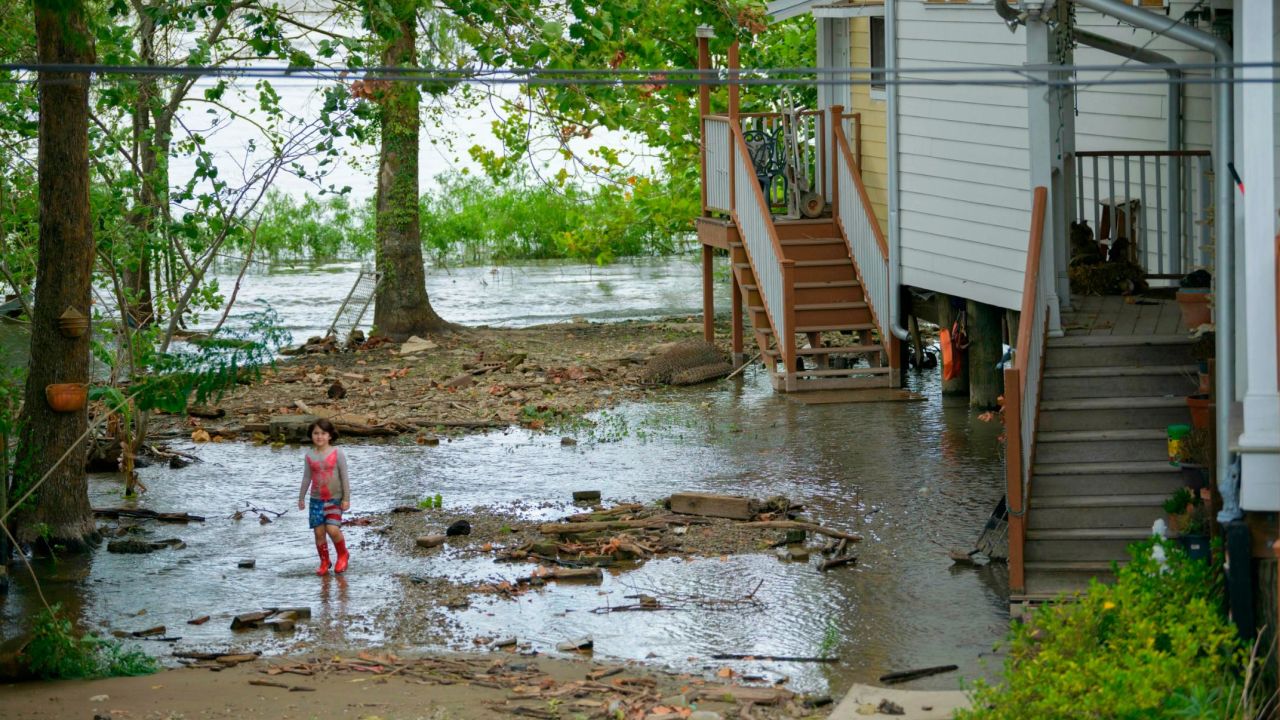 Four-year-old Delilah Campbell clears out driftwood and other debris in preparation of Tropical Storm Barry near New Orleans on Thursday.