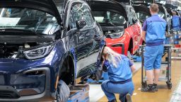 20 May 2019, Saxony, Leipzig: Employees at the BMW plant in Leipzig work on the assembly of the i3. The plug-in hybrid has been built at BMW's Leipzig plant since 2013. It is the first production vehicle with a passenger cell made of carbon fiber-reinforced plastic (CFRP). Photo: Jan Woitas/dpa-Zentralbild/ZB (Photo by Jan Woitas/picture alliance via Getty Images)