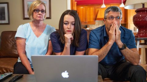 Kaitlin Hurley, center, watches her rapist's sentencing in Antigua via Skype with her parents in their home in Tennessee.