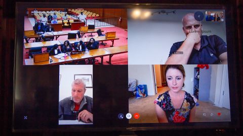 The Hurley family watches the sentencing on their laptop with advocate Annie Clark, bottom right, and members of London's Metropolitan Police.
