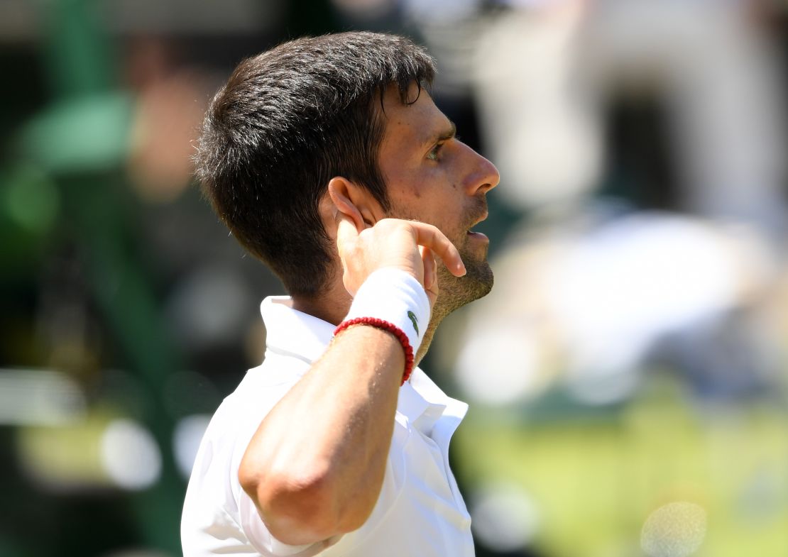 Djokovic points to his ear during his semi-final against Roberto Bautista Agut.