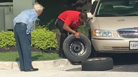 It took Chick-fil-A manager Daryl Howard, right, about 15 minutes to change a flat tire for a 96-year-old WWII veteran employees know as "Mr. Lee."