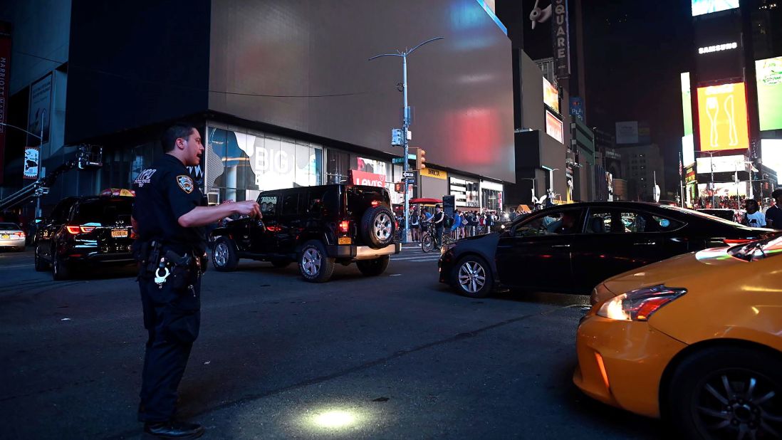 A police officer directs traffic in Times Square.