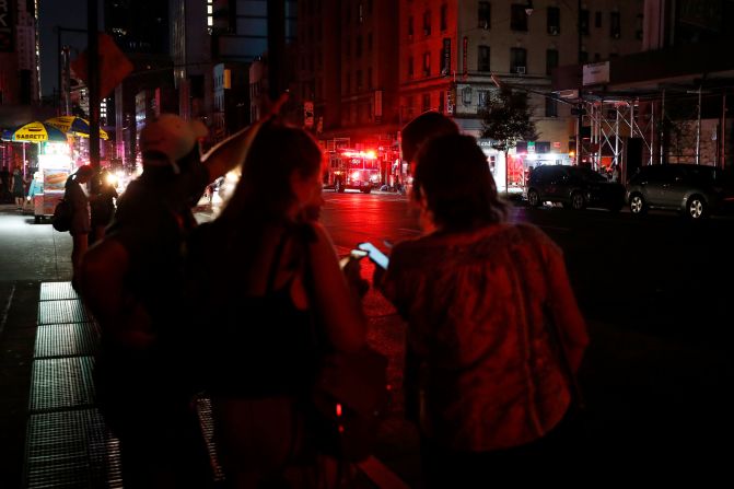 Pedestrians looks at their cellphones in midtown Manhattan.