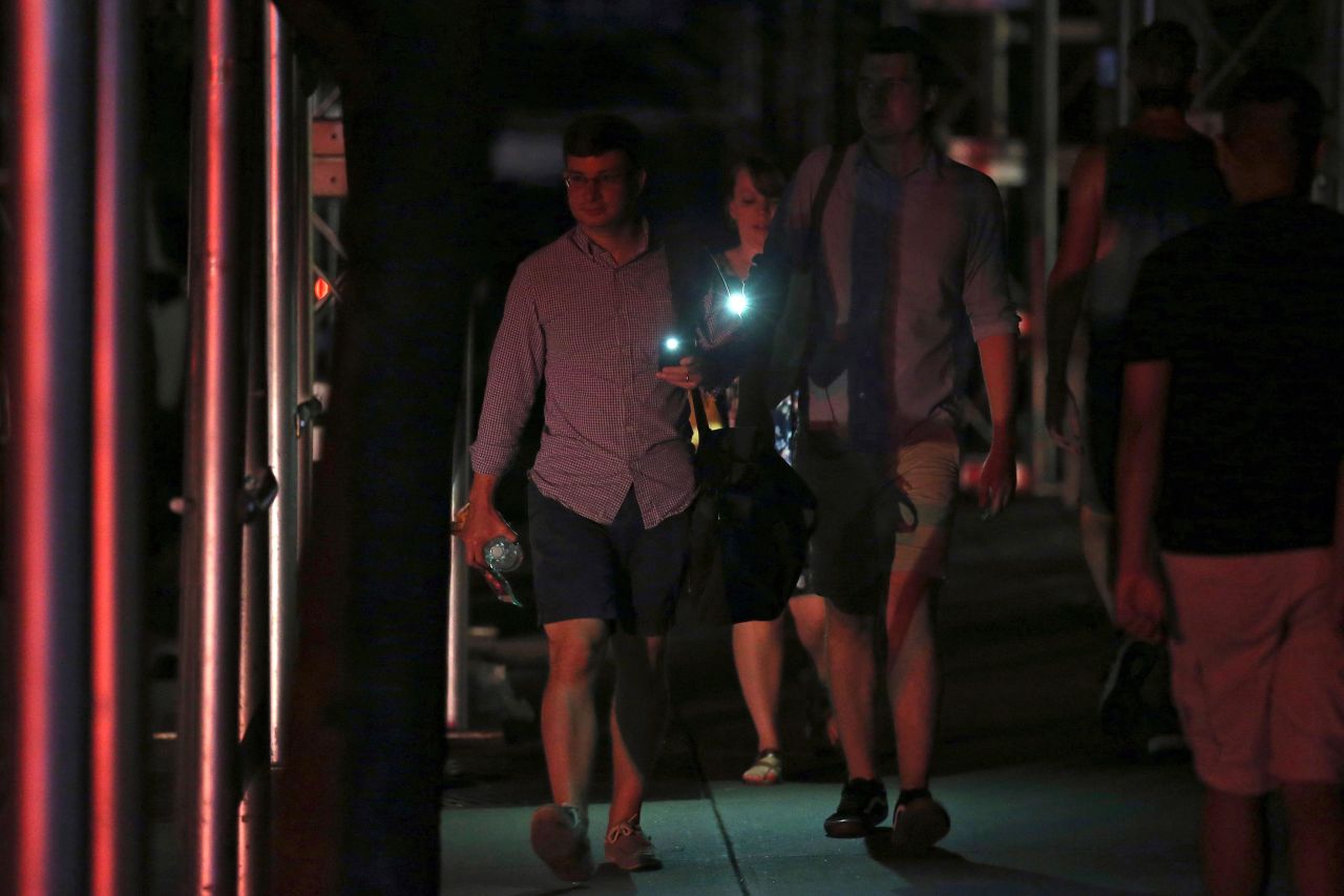 People use their phones as flashlights.