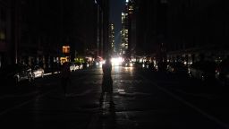 People walk down the streets during a major power outage affecting parts of New York City on July 13, 2019. - Subway stations plunged into darkness and the billboards of Times Square suddenly flicked off as New York's Manhattan was hit by a power outage on Saturday. About 42,000 customers lost electricity in the early evening, according to the Con Edison utility, which did not give a reason for the cut. (Photo by TIMOTHY A. CLARY / AFP)        (Photo credit should read TIMOTHY A. CLARY/AFP/Getty Images)
