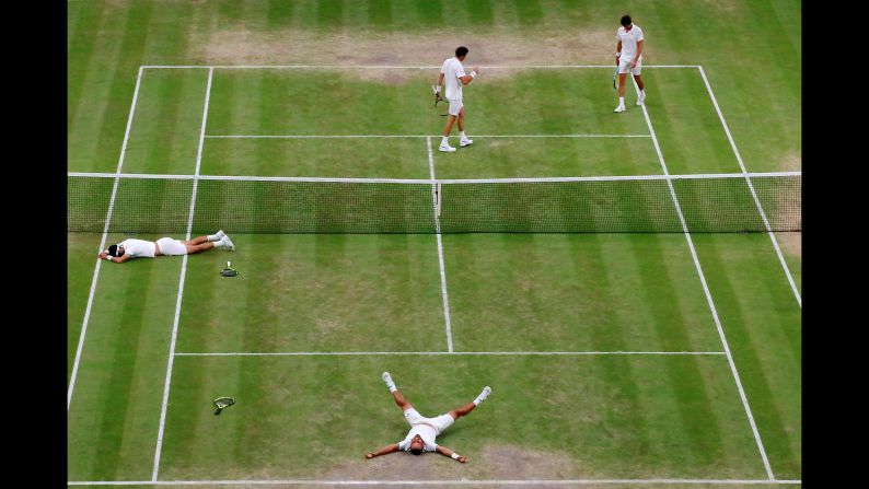Colombia's Juan Sebastian Cabal and Robert Farah, on the ground, celebrate winning the Wimbledon men's doubles final against France's Nicolas Mahut and Edouard Roger-Vasselin on Saturday, July 13.
