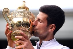 Serbia's Novak Djokovic kisses the winner's trophy after beating Roger Federer in a five-set epic final at Wimbledon.