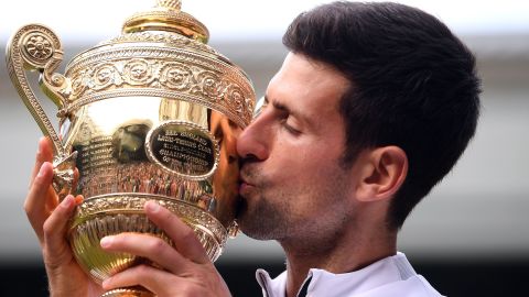 Serbia's Novak Djokovic kisses the winner's trophy after beating Roger Federer in a five-set epic final at Wimbledon.