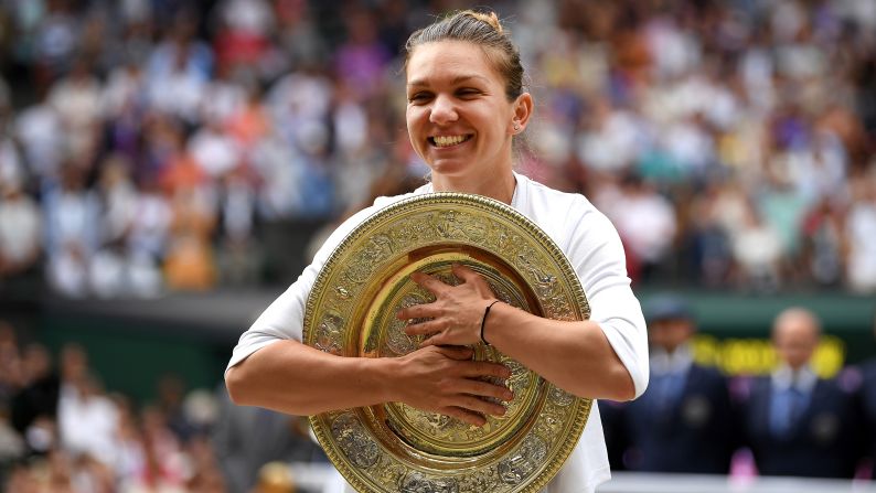 Simona Halep poses for a photo with the trophy after winning the Wimbledon final against Serena Williams.