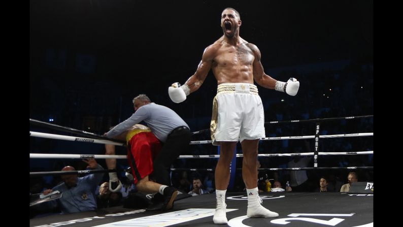 France's Tony Yoka celebrates after winning his heavyweight boxing match against Germany's Alexander Dimitrenko, left, on July 13 in Antibes, southern France.