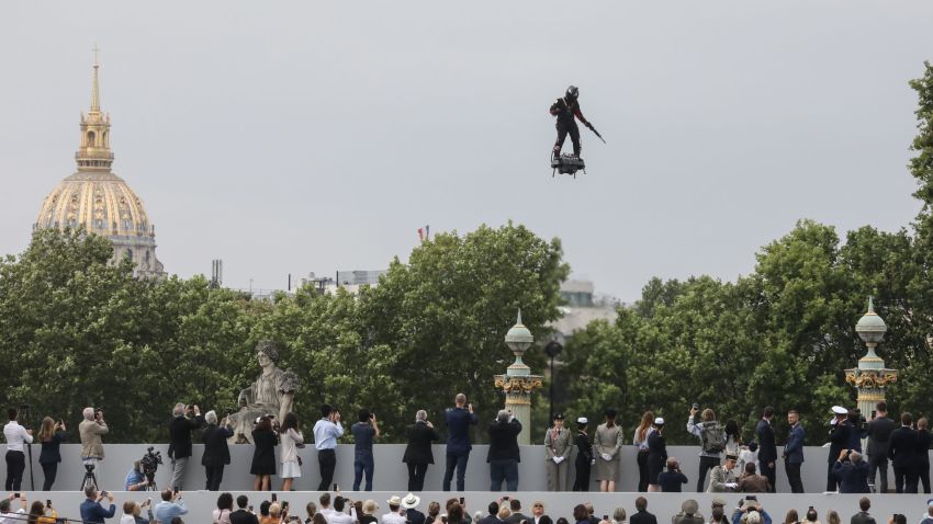 TOPSHOT - Zapata CEO Franky Zapata flies a jet-powered hoverboard or "Flyboard" prior to the Bastille Day military parade down the Champs-Elysees avenue in Paris on July 14, 2019. (Photo by ludovic MARIN / AFP)        (Photo credit should read LUDOVIC MARIN/AFP/Getty Images)