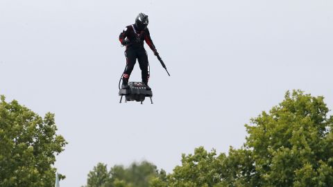 PARIS, FRANCE - JULY 14: Zapata CEO Franky Zapata flies a jet-powered hoverboard or "Flyboard" during the traditional Bastille Day military parade on the Champs-Elysees avenue Avenue on July 14, 2019 in Paris, France. At the invitation of French President Emmanuel Macron, a dozen European leaders, including German Chancellor Angela Merkel and President of the European Commission Jean-Claude Juncker participate in the traditional parade of July 14 which is placed this year under the sign of European military cooperation. (Photo by Thierry Chesnot/Getty Images)