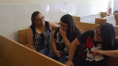 Francisca Lino, left, talks and laughs with her twin 17-year-old daughters Judith, center, and Juliana, right.