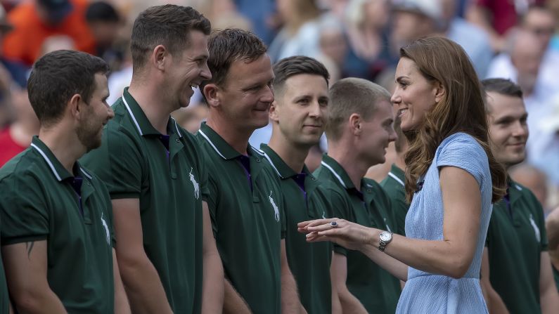 Catherine, Duchess of Cambridge speaks with the Wimbledon groundsmen during the final day of the tennis championship in London.