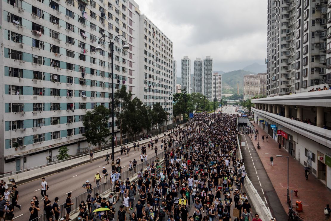 Demonstrators march during a protest in the Sha Tin district of Hong Kong on July 14, 2019. 