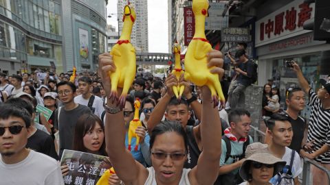 Protestors march to the Tuen Mun Park to protest against the middle-aged female street performers, in Hong Kong, on July 6, 2019. 