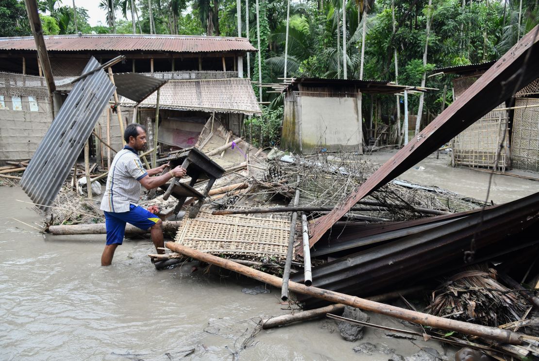 An Indian woman near the debris of her house in the state of Assam, on July 13, 2019.
