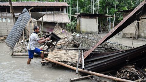 An Indian woman near the debris of her house in the state of Assam, on July 13, 2019.