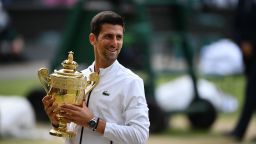 Serbia's Novak Djokovic holds the winner's trophy during the presentation after beating Switzerland's Roger Federer during their men's singles final on day thirteen of the 2019 Wimbledon Championships at The All England Lawn Tennis Club in Wimbledon, southwest London, on July 14, 2019. (Photo by Daniel LEAL-OLIVAS / AFP) / RESTRICTED TO EDITORIAL USE        (Photo credit should read DANIEL LEAL-OLIVAS/AFP/Getty Images)