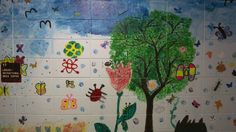 Murals showing kids' paintings still adorn the hallways in the former school building.