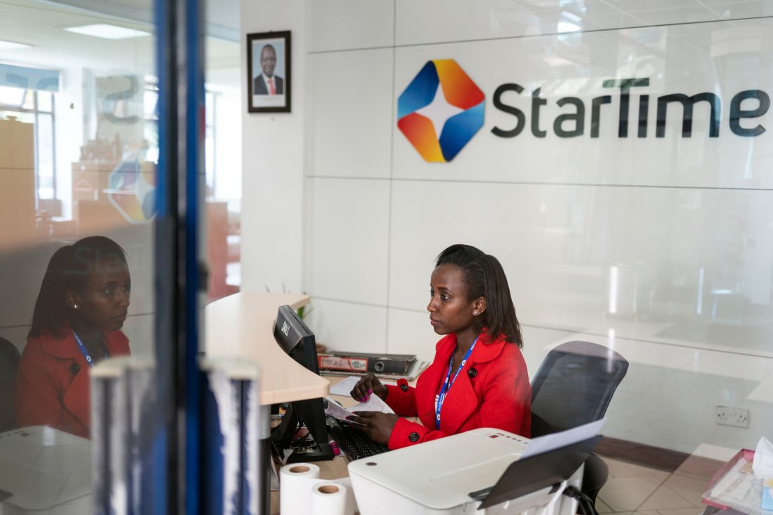 A receptionist sits at her desk in the lobby of the StarTimes headquarters in Nairobi.