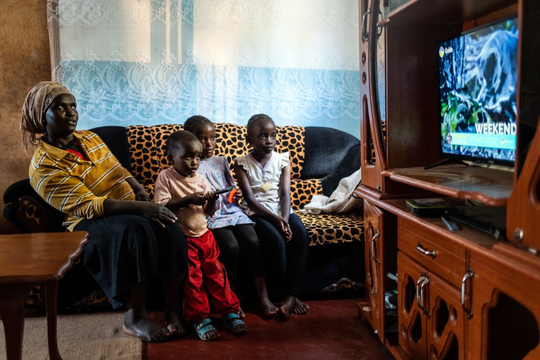 StarTimes subscriber Purity Njambi watches television with her children, from left, James Ngugi, Margaret Wahu and Agnes Wambui at their home in the Ndumbuini village.