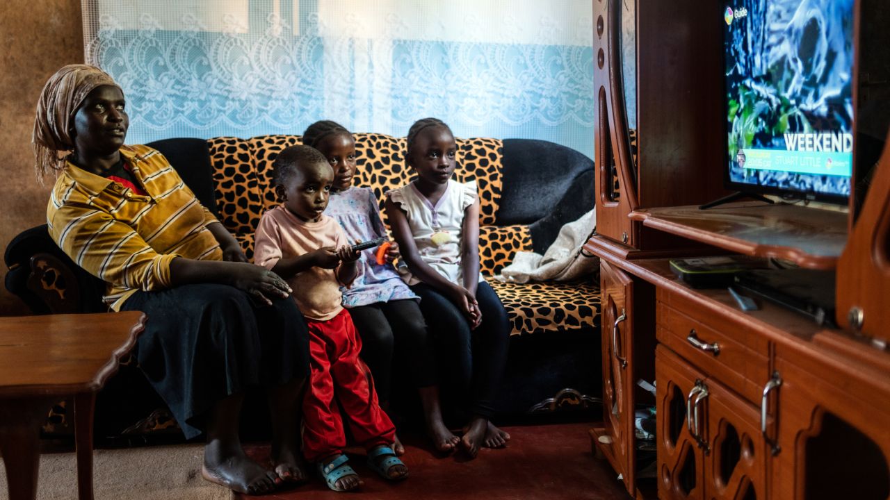 StarTimes subscriber Purity Njambi watches television with her children, from left, James Ngugi, Margaret Wahu and Agnes Wambui at their home in the Ndumbuini village.