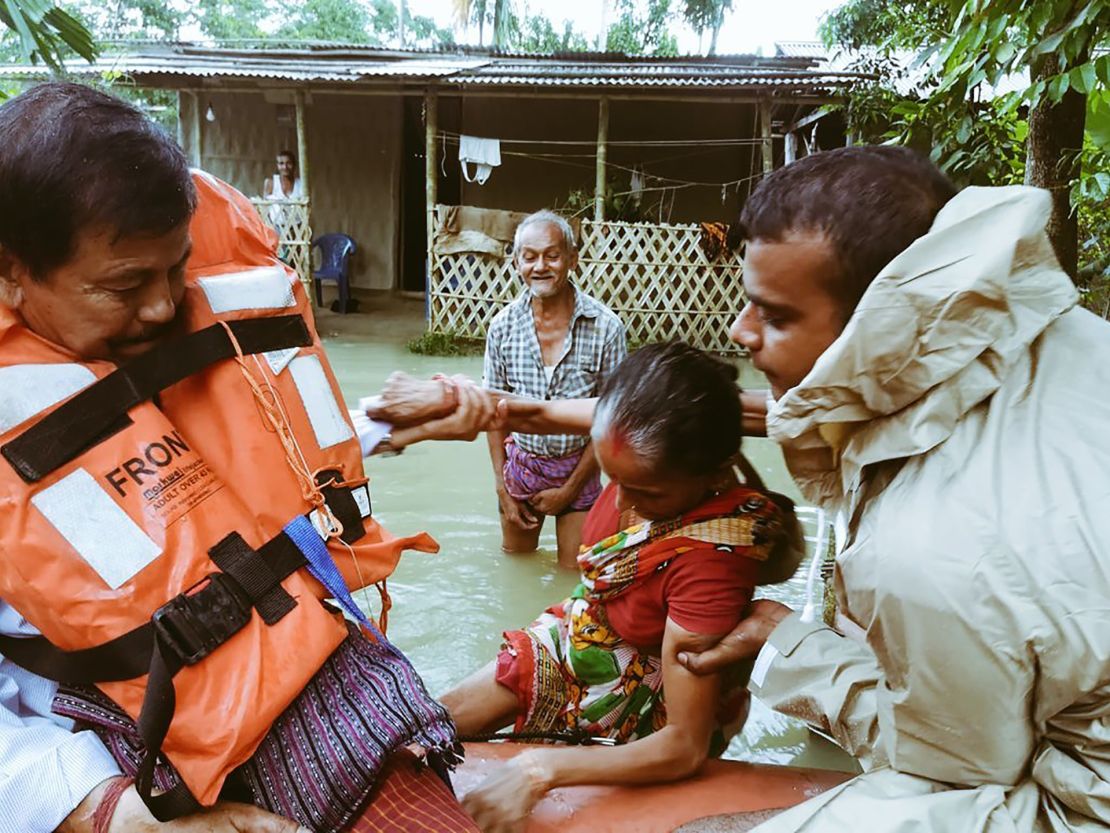India's National Disaster Response Force evacuate people in flooded parts of Assam state.