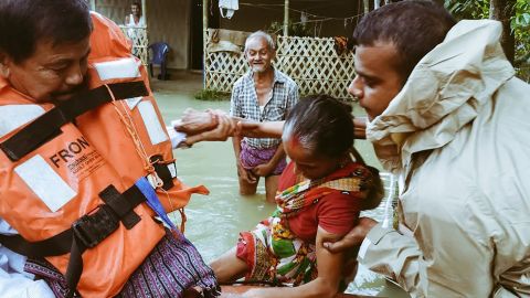 India's National Disaster Response Force evacuate people in flooded parts of Assam state.