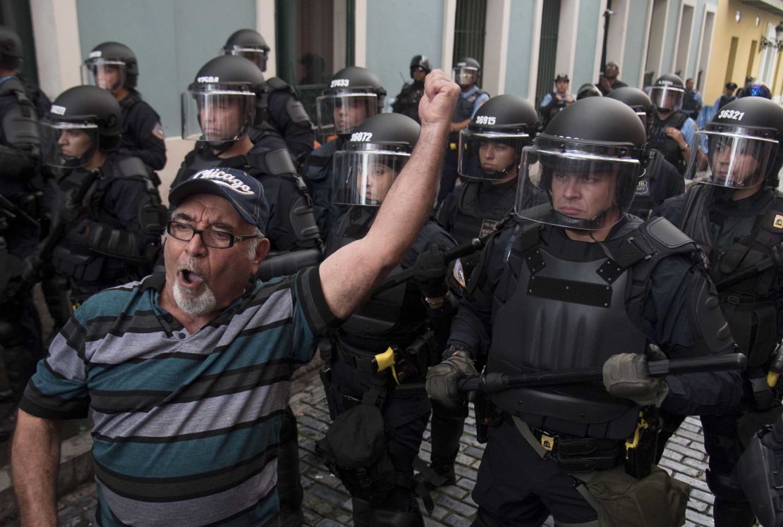 Police block demonstrators from advancing to La Fortaleza governor's residence in San Juan Sunday.