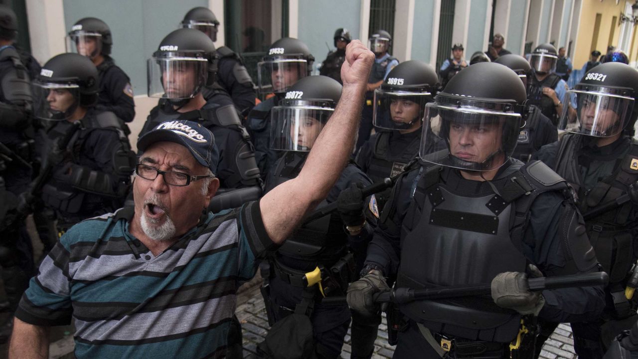Police block demonstrators from advancing to La Fortaleza governor's residence in San Juan Sunday.