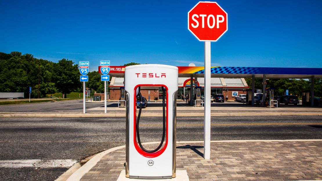 A Tesla Supercharger across the street from a gas station off Interstate-95 in Newark, Delaware.