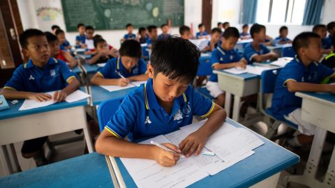 Boys attending an English class at the Guangzhou R&F Football Academy in southern China's Guangdong province, in September 2018.