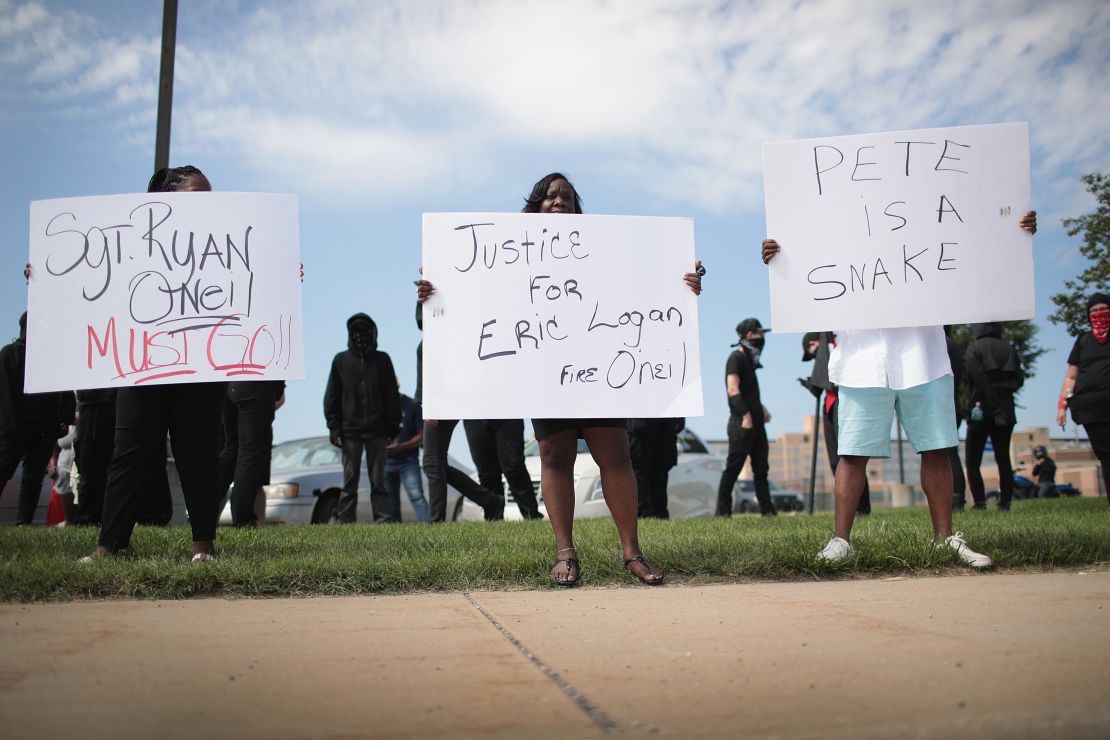 Demonstrators call for the resignation of the officer who shot Eric Logan.