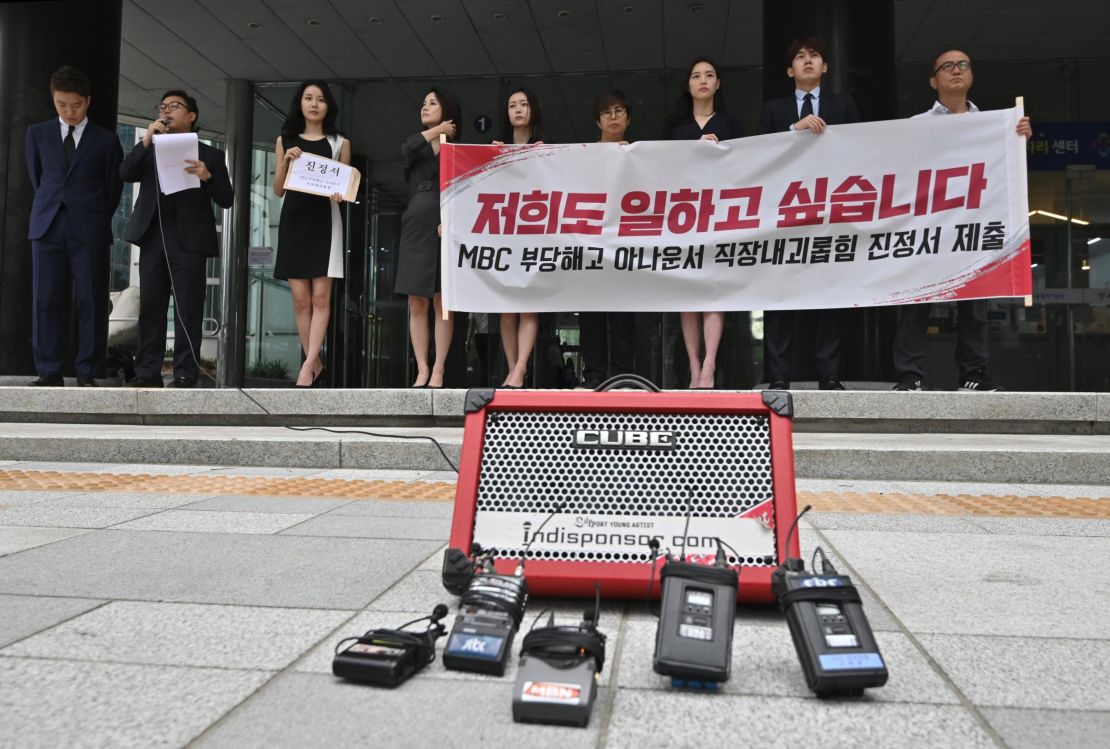 South Korean news presenters of the local TV network Munhwa Broadcasting Corporation hold a rally before submitting a complaint on workplace harassment to the employment and labor office in Seoul on July 16, 2019. 