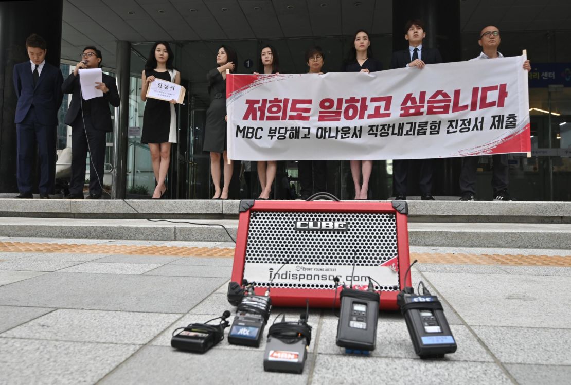 South Korean news presenters of the local TV network Munhwa Broadcasting Corporation hold a rally before submitting a complaint on workplace harassment to the employment and labor office in Seoul on July 16, 2019.