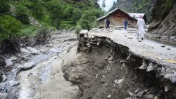 Villagers walk along a road washed away by heavy flooding in Neelum Valley of Pakistani controlled Kashmir, Monday, July 15, 2019. Pakistan says many people are missing and feared dead after heavy rains triggered flash floods in Pakistani-controlled Kashmir. Ahmed Raza Qadri, the Pakistani minister for disaster management in the disputed territory, says the flooding late on Sunday also caused much destruction and damage in the village of Lesswa in Neelum Valley.